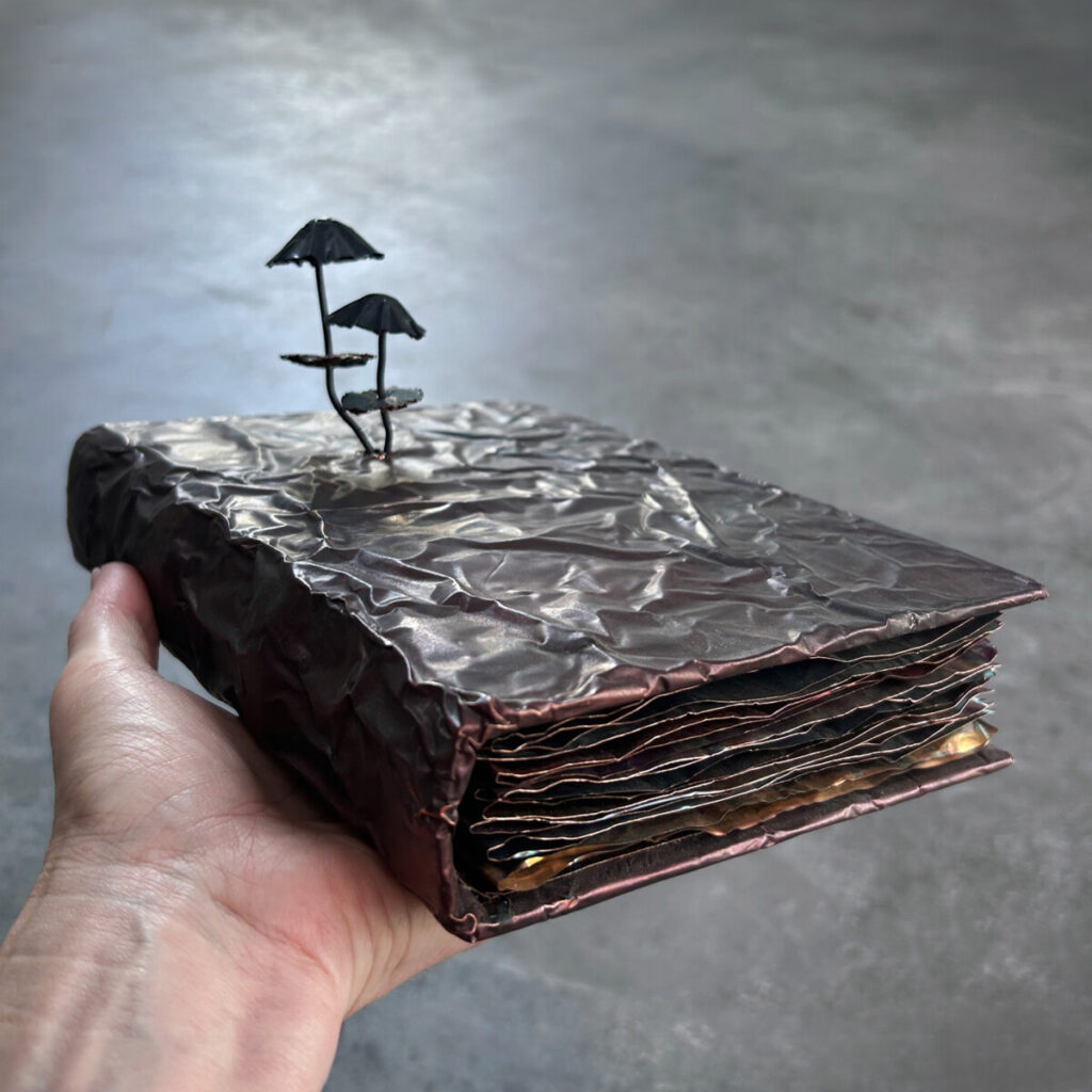 PhD Thesis: How to Manage Mushrooms held in hand, copper mushrooms bursting through the marbled cover