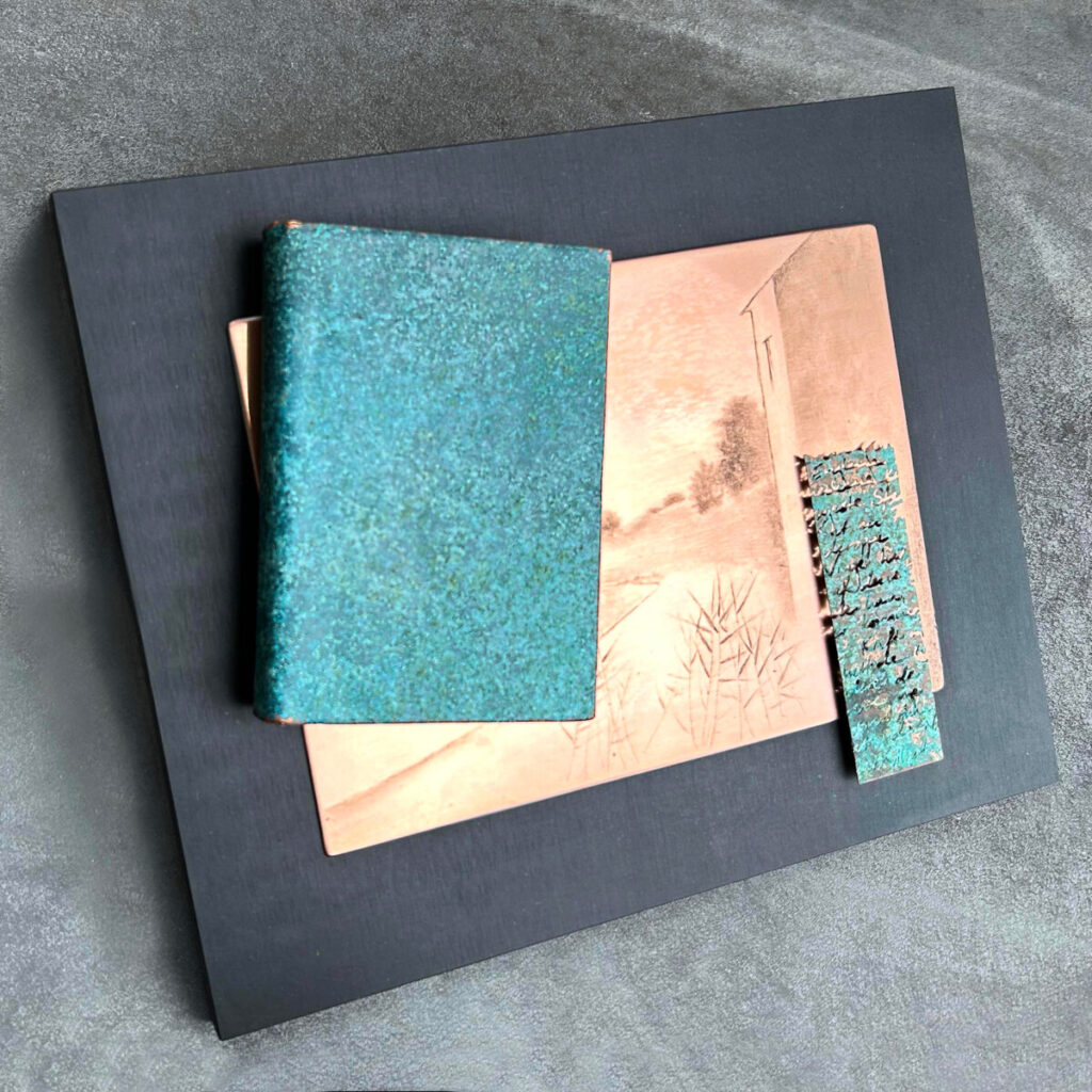 Travel Diary of a Poet against a black background, a turquoise patinated copper book with an inset Gunnar Norrman drypoint plate and etched text