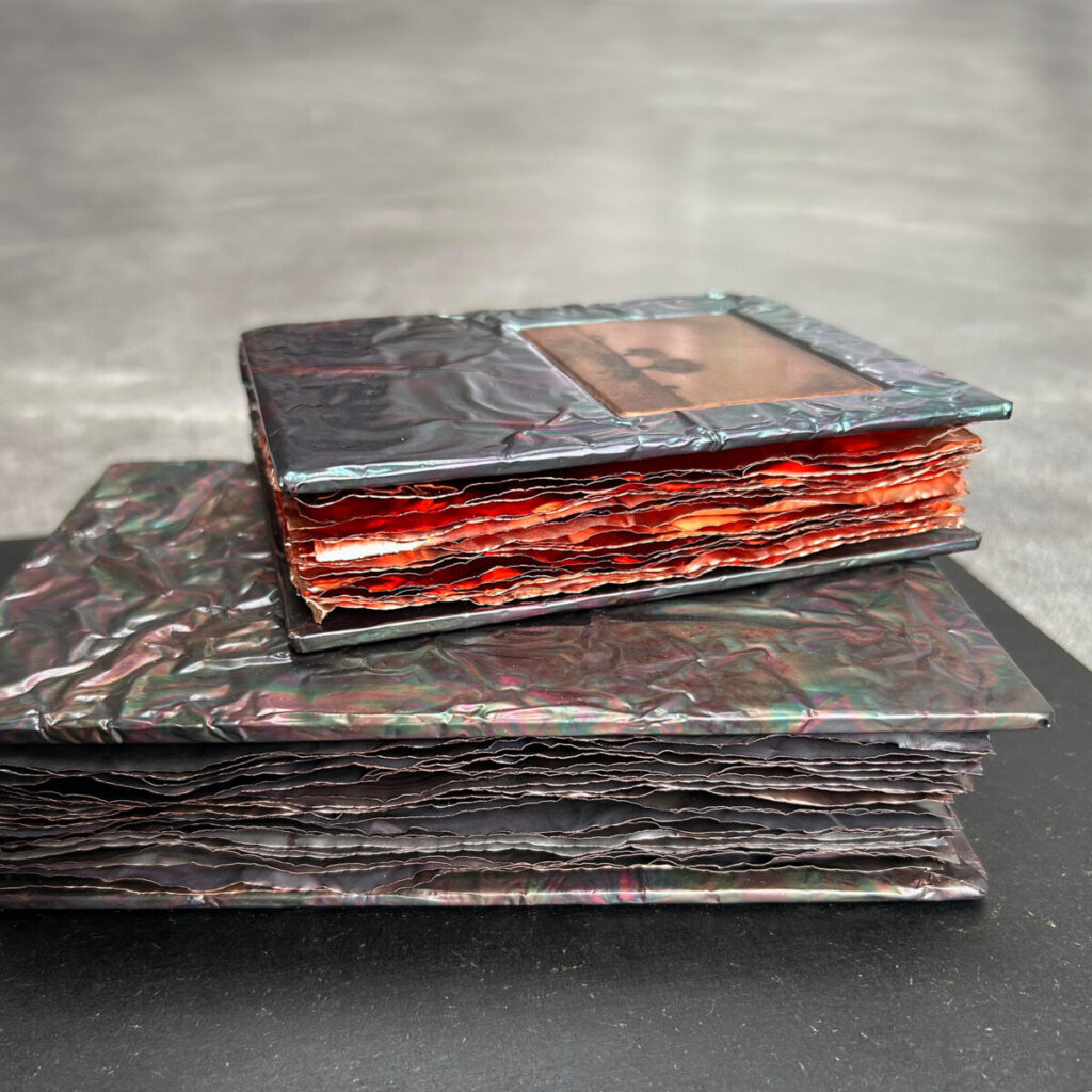 Two Unforgettable Seasons, two stacked patinated copper books with a Gunnar Norrman drypoint plate on the upper cover